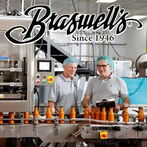 Two men checking jars on the Braswell&rsquo;s bottling line
