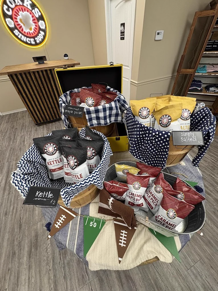 Bags of Corks kettle corn and caramel corn in a shop display